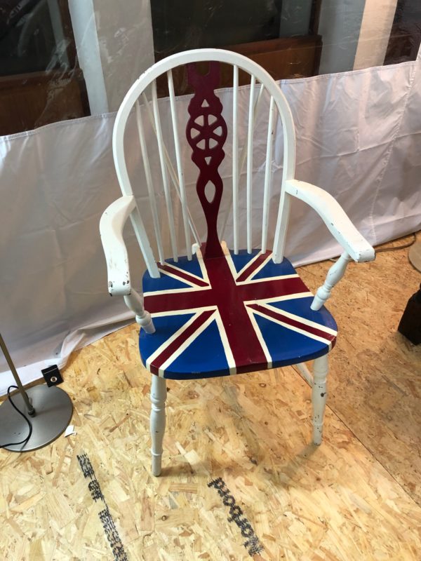 A White Wood Chair With Flag Paint