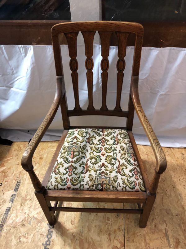 A Wood Table With Floral Cushion