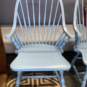 Six captain’s chairs that have been painted in blue