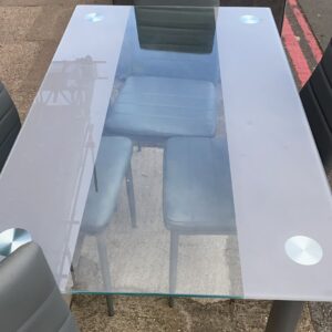 Contemporary glass top table with grey legs with four matching chairs with grey legs