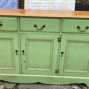 Solid pine sideboard which has been painted green with cupboards and drawers