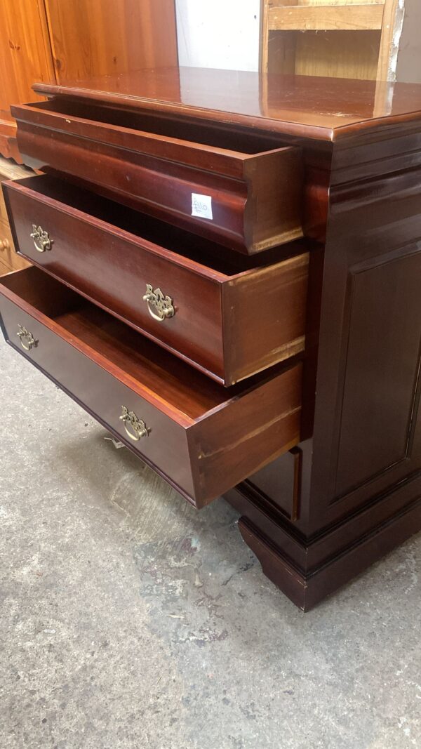 Cherry coloured four drawer chest of  drawers with brass handles