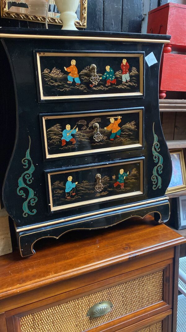 Ebony painted oriental three drawer cupboard