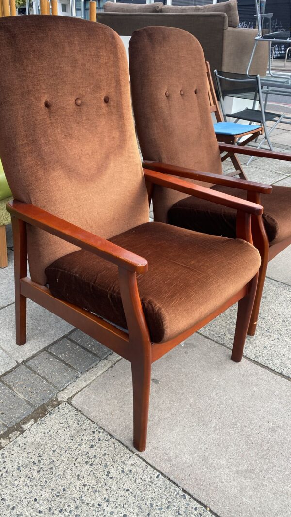 Two brown fireside chairs with teak coloured arms